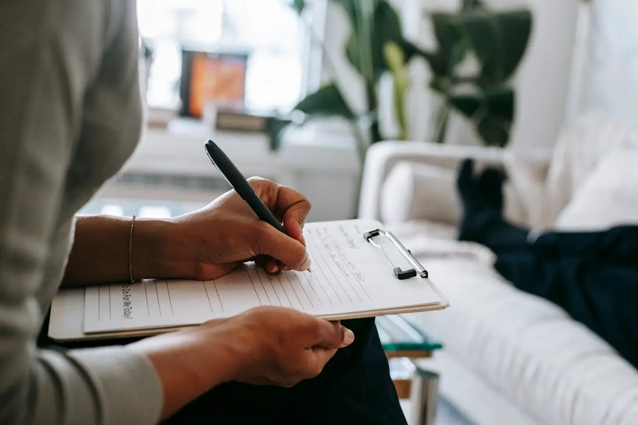 A person taking notes on a clipboard